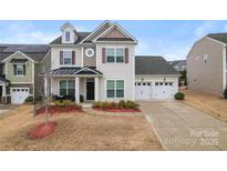 Inviting two-story home featuring a two-car garage and well-manicured landscaping at 966 Nw Parkland Pl, Concord, NC 28027
