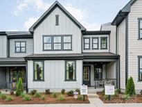 Charming two-story home with white siding, black trim, and a well-manicured front yard at 123 Armstrong Rd, Belmont, NC 28012