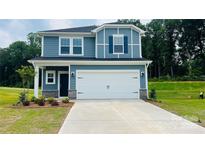 Two story home with blue siding, white trim, dark blue door and two car garage at 141 Satchel Ct, Mooresville, NC 28115