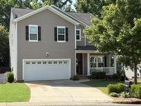 Charming two-story home with a two-car garage and well-maintained lawn at 1673 Beleek Ridge Ln, Clover, SC 29710