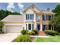 Two-story home with manicured lawn, brick and siding exterior, attached garage, and mature landscaping at 2019 Steeplechase Dr, Rock Hill, SC 29732