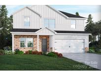 Charming two-story home with a brick and white siding facade and a two car garage in a manicured, landscaped setting at 2143 Rolling Hills Ct, Stanley, NC 28164