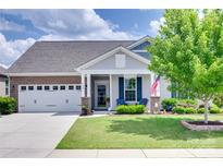 Charming single-story home with a two-car garage, inviting front porch, and manicured lawn at 3145 Bridgewater St, Lancaster, SC 29720