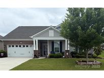Charming single-story home featuring a well-manicured lawn and attached two car garage at 3145 Bridgewater St, Lancaster, SC 29720