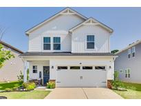 Charming two-story home with a well-manicured lawn and a welcoming front porch at 322 Olympia Way, York, SC 29745