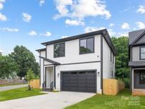 Charming two-story home featuring a modern design, black trim and a well-manicured front yard at 3903 Plainview Rd, Charlotte, NC 28208
