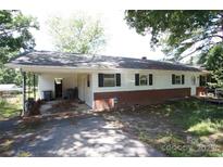 Ranch-style home with carport, brick foundation, and white siding ready for upgrades and personal touches at 402 Villa St, Kannapolis, NC 28083
