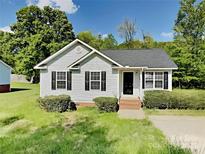 Charming single-story home with gray siding, black shutters, and a neatly maintained front yard at 4328 Frank Vance Rd, Charlotte, NC 28216