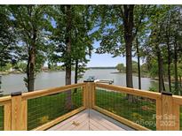 Lake view from the deck with cable railing, wooden posts, and adjacent trees at 5075 Lakeview Cir, Sherrills Ford, NC 28673