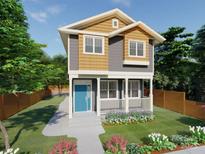 Charming two-story home with a welcoming porch, blue front door, and meticulously landscaped front yard at 614 Kings Mountain St, Clover, SC 29710