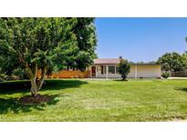Charming single-story home with a well-manicured front lawn and mature landscaping at 920 Thomas St, Statesville, NC 28677