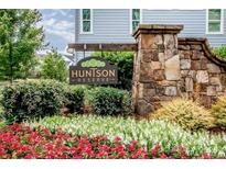Stone community sign for Huntson Reserve with beautiful landscaping and inviting design at 13708 Huntson Park Ln, Huntersville, NC 28078