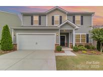 Two-story home featuring neutral siding, black shutters, a two-car garage and manicured landscaping at 2037 Christopher Wood Ct, Fort Mill, SC 29707
