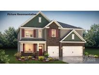 Charming two-story home with gray siding, brick accents, and a well-manicured lawn creating great curb appeal at 2876 Atwater Pond Cir, Denver, NC 28037