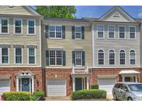 Charming townhome with brick accents, a one car garage and manicured landscaping at 3014 Castleberry Ct, Charlotte, NC 28209