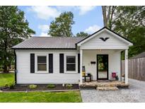 Charming home featuring a metal roof, black-framed windows, and a cozy front porch with stone steps at 310 S Jacob St, Cherryville, NC 28021