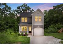 Charming two-story home featuring a gray and white exterior, attached garage and well-maintained landscaping at 510 3Rd St, Salisbury, NC 28144