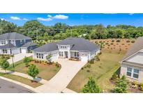 Stunning single story home with well manicured lawn, elegant landscaping, and a long concrete driveway at 513 Meadow Ridge Dr, Belmont, NC 28012