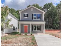 Charming two-story home with a welcoming front porch and a modern gray facade at 560 Ridge Ave, Mooresville, NC 28115