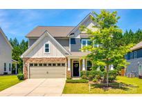 Charming two-story home with stone accents, inviting front entrance, and manicured landscaping at 5635 Agora Ct, Lancaster, SC 29720