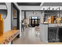 Modern living room featuring an open floor plan, hardwood floors, and access to a balcony with a neighborhood view at 720 Governor Morrison St # 219, Charlotte, NC 28211