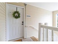 Charming front door with wreath and stylish hardware, creating a welcoming entrance at 1108 Plaza Walk Dr, Charlotte, NC 28215