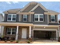 Charming two-story home featuring a welcoming front porch and attached two-car garage at 180 Ella Claire Dr, York, SC 29745