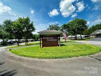 Charming Needle Stone Townhomes with lush green grass and mature trees under a bright blue sky at 2541 26Th Ne Ave, Hickory, NC 28601