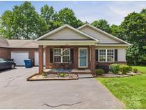 Charming single-story home with a brick facade, complemented by a well-maintained lawn and front yard landscaping at 2541 26Th Ne Ave, Hickory, NC 28601