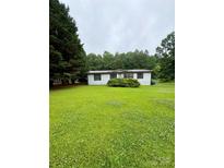 Charming single-story home with fresh green lawn and mature trees at 5022 Wrenn Dr, Denver, NC 28037