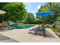 Backyard pool area provides a luxurious space for relaxing and entertaining with ample lounge seating at 6313 Weddington Rd, Concord, NC 28027