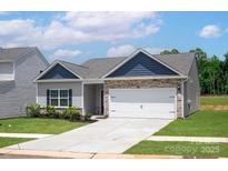 Charming one-story home with stone accents, gray siding, well-maintained lawn, and a two-car garage at 7217 Jerimoth Dr, Charlotte, NC 28215
