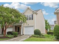 Inviting two-story home featuring a one car garage and manicured lawn at 14018 Drake Watch Ln, Charlotte, NC 28262