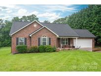 Charming brick home with lush lawn, two-car garage, and a manicured front yard at 1483 Dawnview Ln, Lincolnton, NC 28092