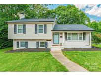 Charming two-story home with white siding, black shutters, and a well-manicured front yard at 1645 Brookdale Ave, Charlotte, NC 28210
