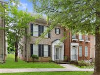 Charming brick townhome with black shutters, a landscaped yard, and a welcoming front entrance at 181 Singleton Rd, Mooresville, NC 28117
