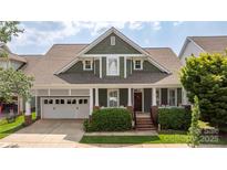 Charming craftsman-style home with a well-manicured lawn and a welcoming front porch at 188 Lilac Mist Loop, Mooresville, NC 28115