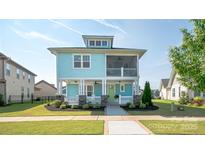 Charming two-story home featuring a double porch, vibrant blue siding, and beautifully landscaped front yard at 282 Auburn View Rd, Rock Hill, SC 29730