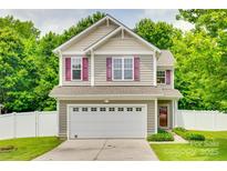 Charming two-story home with a two-car garage, neutral siding, red shutters, and a well-maintained front yard at 288 Sand Paver Way # 50, Fort Mill, SC 29708