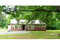 Charming single-story home featuring a metal roof, neutral siding, and a well-maintained front yard at 301 Carolina Blvd, Salisbury, NC 28146