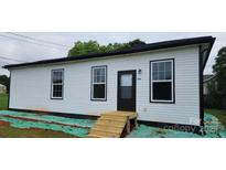 Charming single-story home featuring classic white siding and a welcoming front entrance at 306 E Ratchford Ave, Gastonia, NC 28054