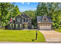 Charming two-story home with a lush green lawn, a separate garage, and a welcoming curb appeal at 315 Wood Duck Loop, Mooresville, NC 28117