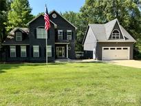 Charming two-story home with manicured lawn and detached garage at 315 Wood Duck Loop, Mooresville, NC 28117
