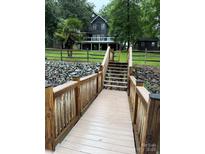Beautiful waterfront home featuring a private dock and lush landscaping in a serene setting at 315 Wood Duck Loop, Mooresville, NC 28117
