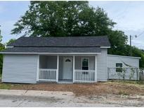 Charming single-story home with a welcoming front porch and newly installed siding at 39 E White St, Chester, SC 29706