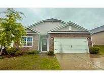 Charming single-Gathering home featuring stone accents, a two-car garage, and a well-maintained front lawn at 4020 Lampasas Ln, Charlotte, NC 28214