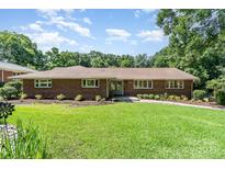 Charming brick home with a well-manicured lawn and lovely landscaping at 5424 Doncaster Dr, Charlotte, NC 28211