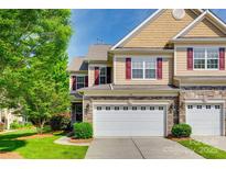 Charming two-story home featuring a two-car garage, manicured lawn, and classic architectural details at 714 Deerbrook Ln, Tega Cay, SC 29708