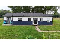Charming one-story home features a blue and white exterior, black front door and well-maintained lawn at 751 Northbrook Iii School Rd, Vale, NC 28168