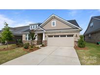 Charming home with a two-car garage, brick facade, manicured lawn, and inviting curb appeal at 9435 Liberty Hill Dr, Mint Hill, NC 28227